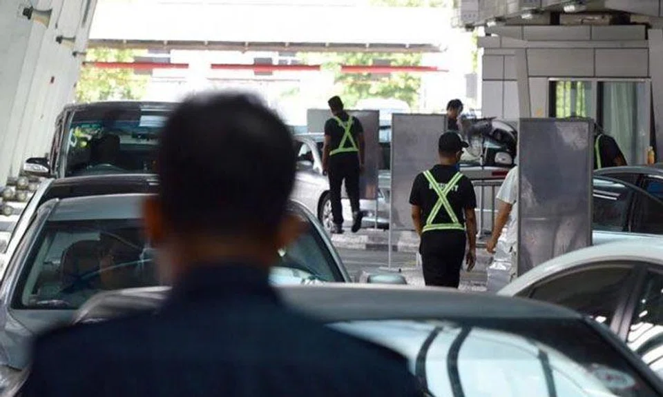 Two AETOS officers working at Woodlands Checkpoint were arrested for terrorism-related offences last month. PHOTO: SHIN MIN FILE