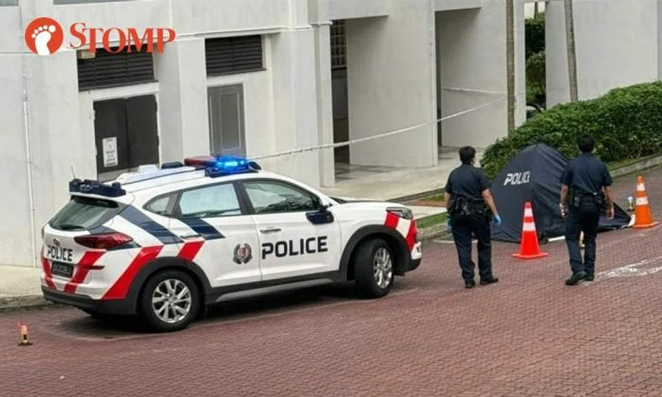 Police vehicles and a blue police tent at Block 17A Telok Blangah Crescent