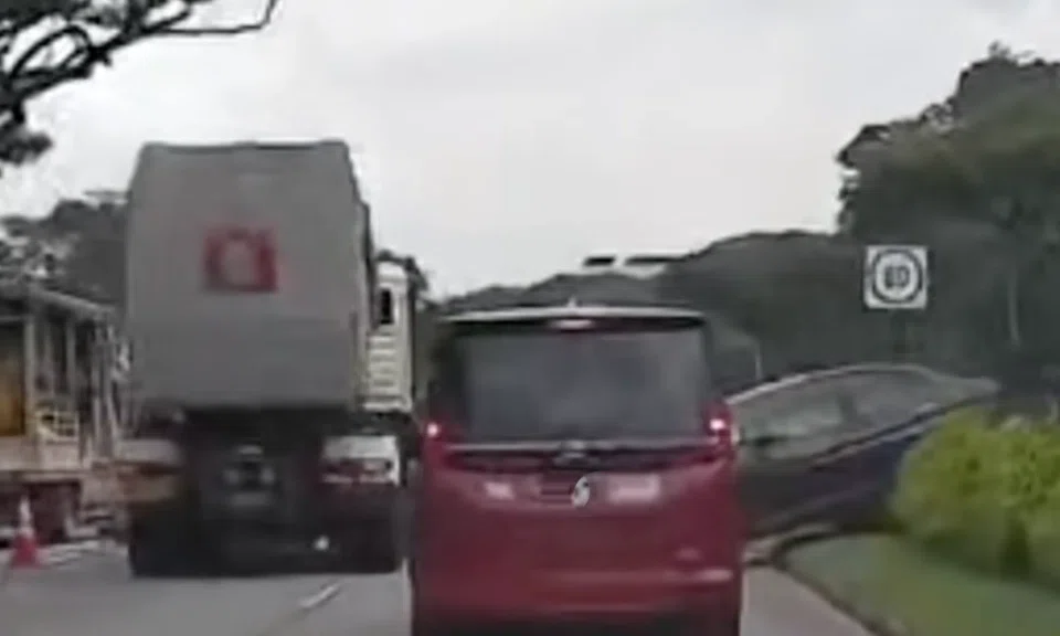 The car ended up on the median strip on Bedok North Flyover after switching lanes to avoid the stalled vehicle in the left-most lane.