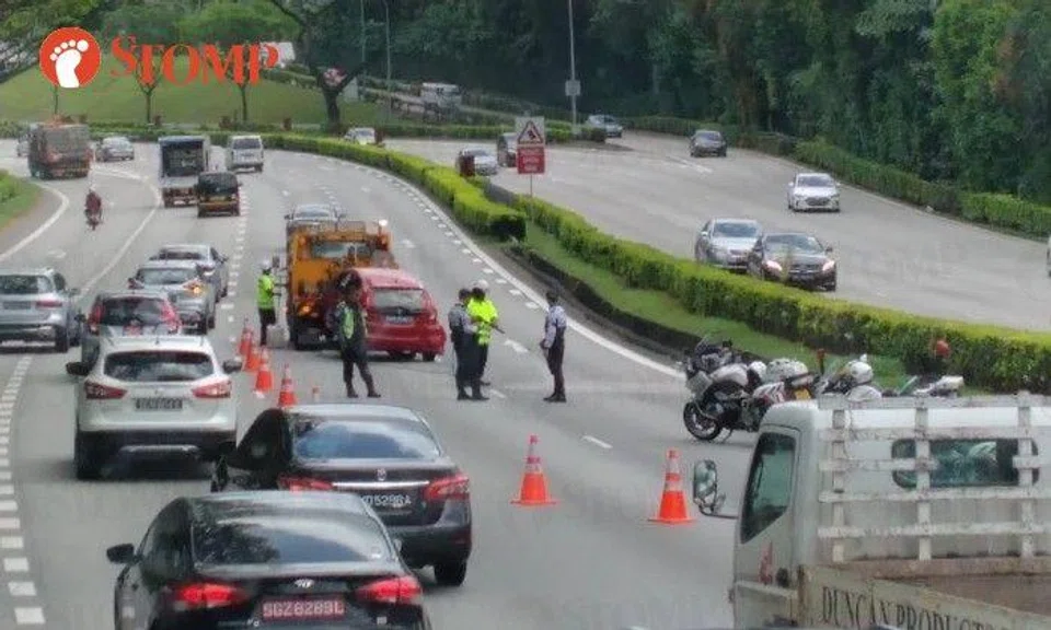 Photos of the accident show a damaged red Honda waiting to be towed away and causing a traffic jam on the expressway. 