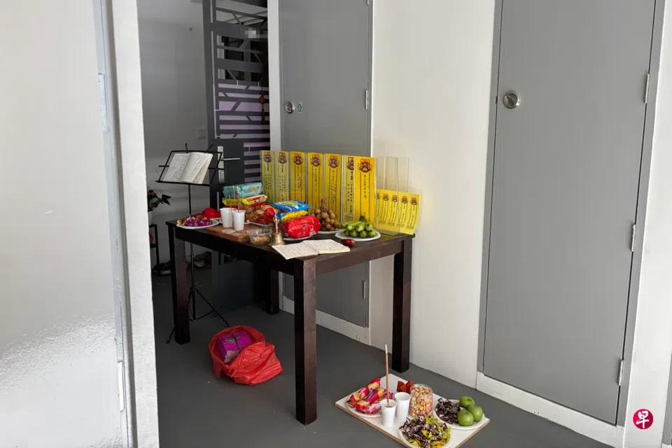 The woman placed ritual offerings outside her unit in the shared corridor.