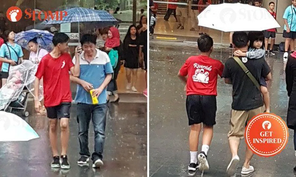 Students graciously shelter members of public with umbrellas from Woodlands Civic Centre to Causeway Point
