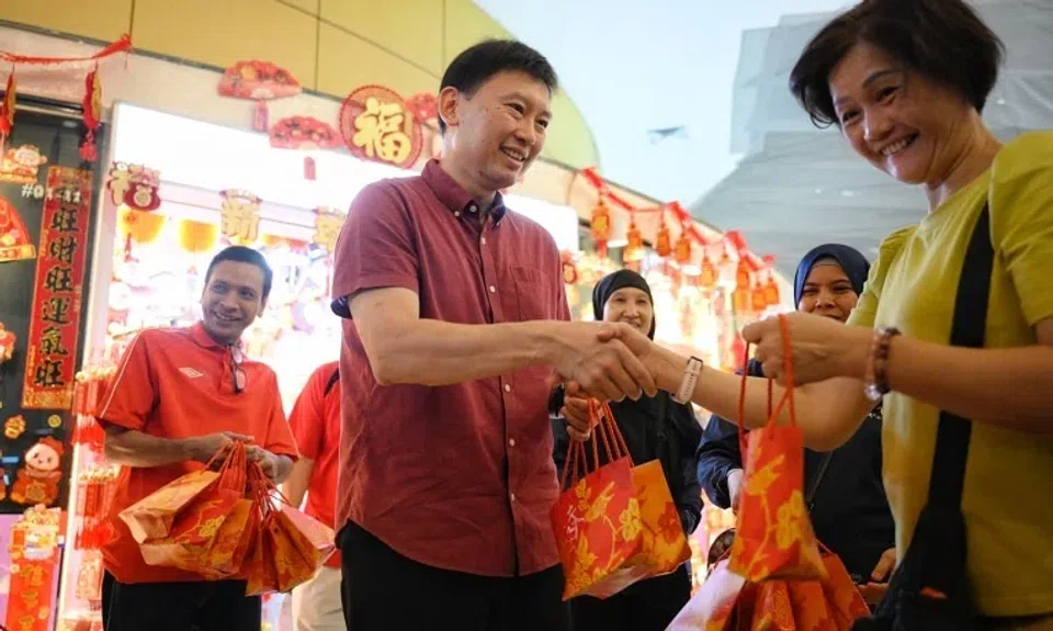 Transport Minister Chee Hong Tat giving out mandarin oranges at a community event on Jan 26.