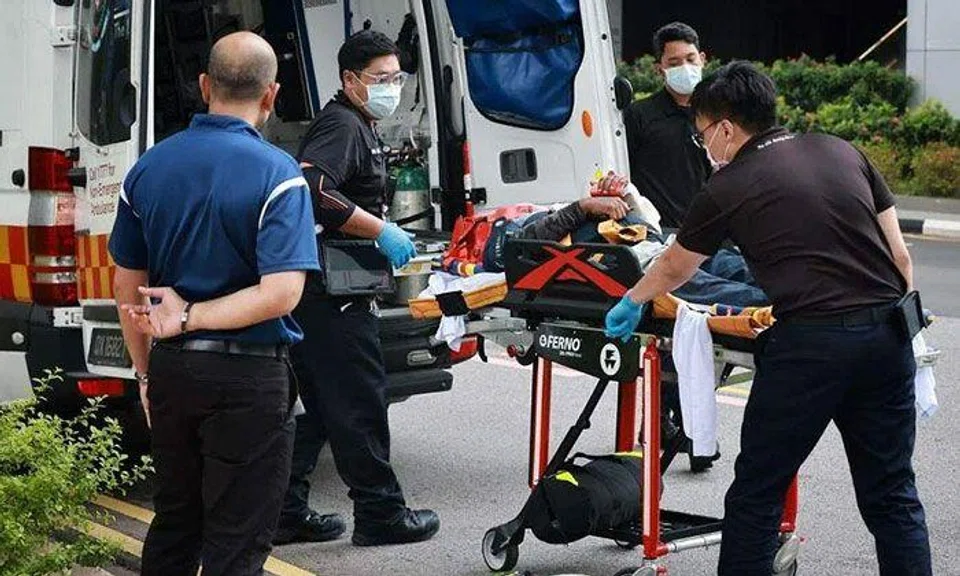SCDF officers preparing to move an injured person into an ambulance, following an incident involving a stuck gondola at 168 Robinson Road on March 20, 2023. ST PHOTO: JASON QUAH