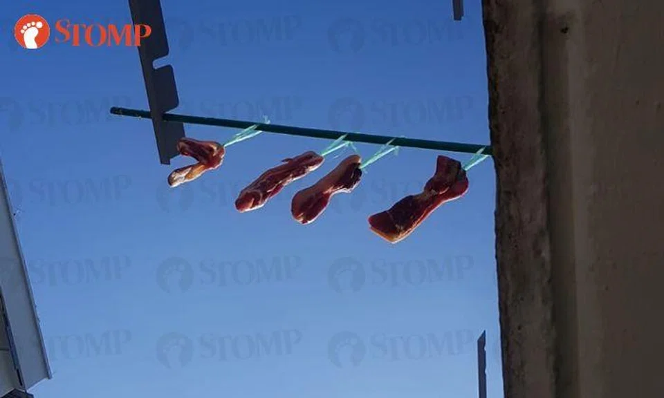 Yishun family removes meat hung at laundry rack after visit from town council