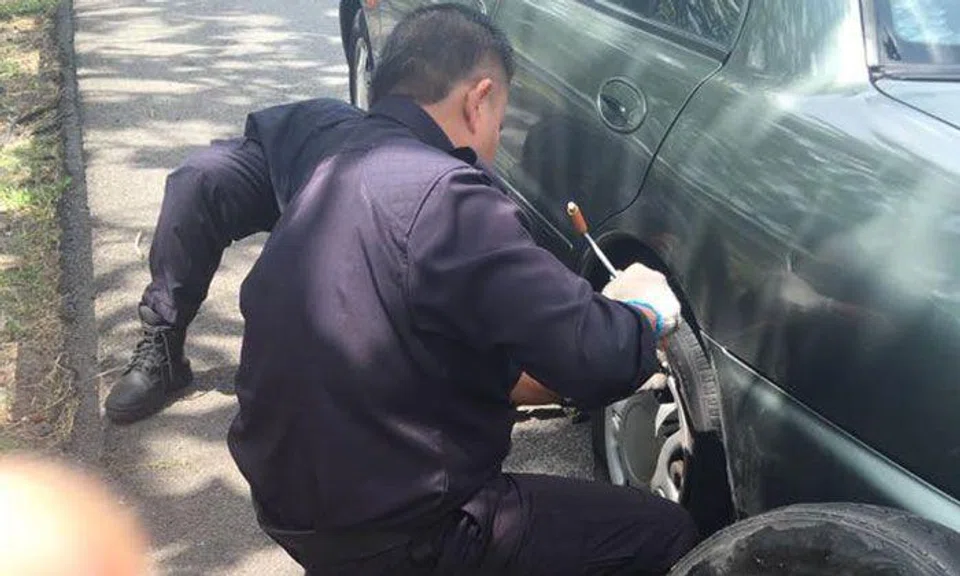 Kind police officers come to the rescue after Malaysian woman's car tyre gets punctured on highway