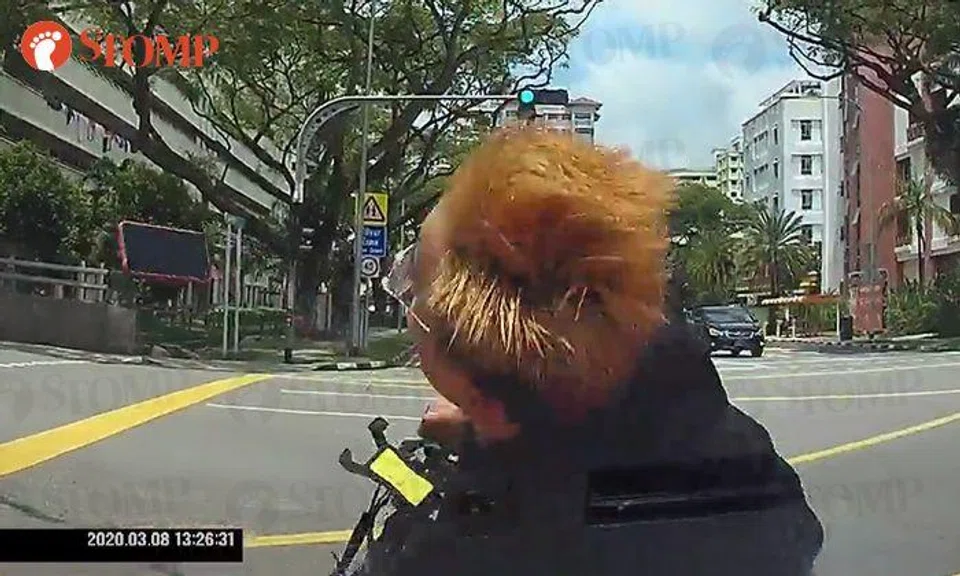 Driver knocks down PMD user who used phone while riding across road in Woodlands