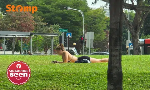 Stomper puzzled to see woman in bikini top suntanning on Geylang grass patch: 'This is not London'