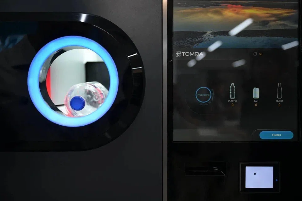 TOMRA, one of three reverse vending machine operators under the scheme, will be setting up at least 350 machines in the central and north-east regions.  ST PHOTO: NG SOR LUAN