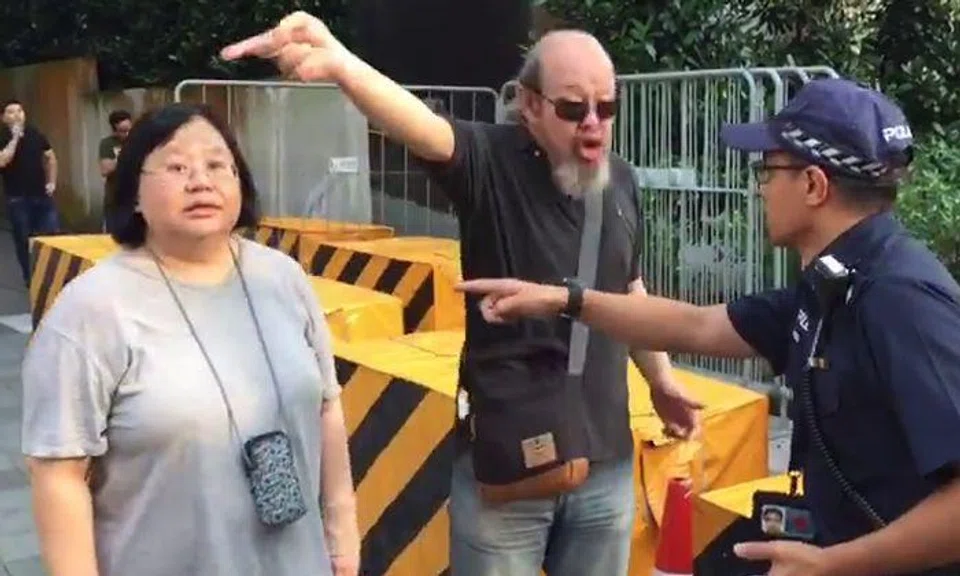Uncle and auntie shout at police officer -- who handles it calmly like a pro
