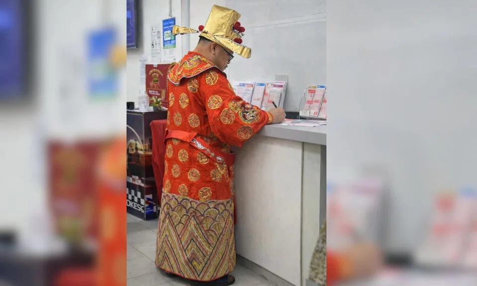 The God of Fortune was spotted apparently buying Toto a day before the $12 million Hong Bao draw, leaving amused netizens lamenting in jest that times are bad.