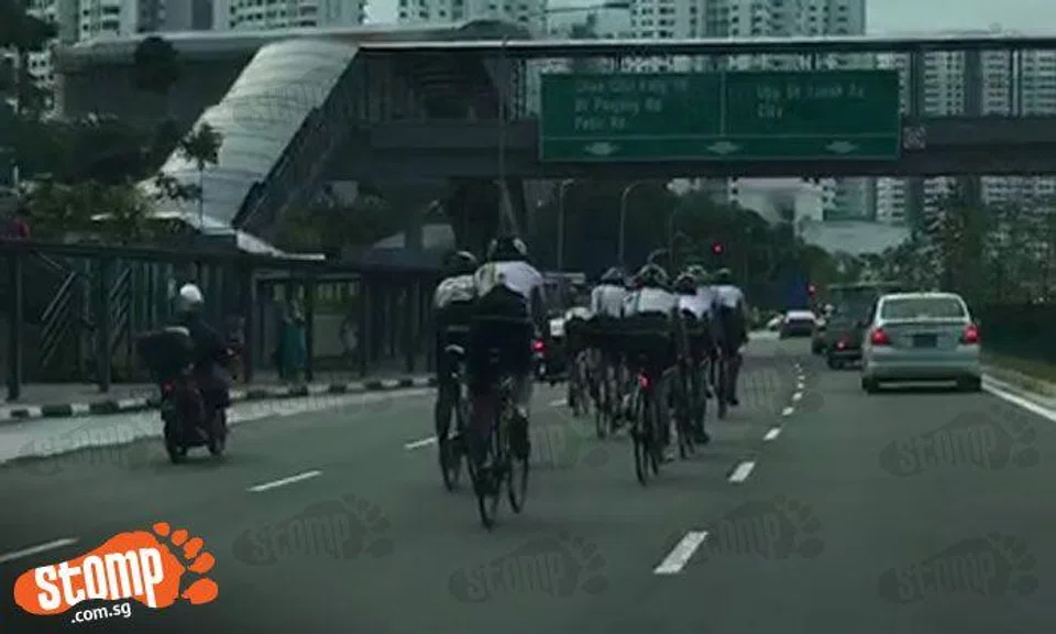 Group of cyclists take up middle lane while cycling along Upper Bukit Timah Road