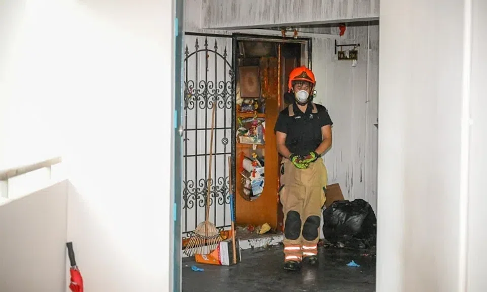 An SCDF firefighter at a flat in Block 971 Hougang Street 91 on Jan 10, a day after a fire broke out at the unit.