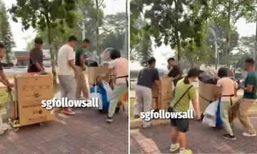 off-duty NSFs help elderly woman with trolley at Kranji