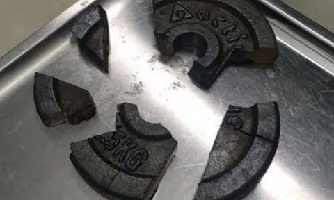 The gym weight plate was broken into five pieces, after firefighters used power tools to free the man from it. 