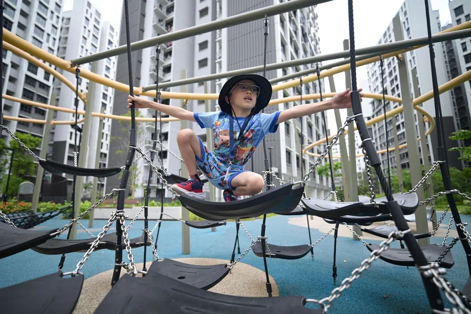 Lim Jun Kai, seven, manoeuvring through the obstacle course's swinging rubber hammock mats.