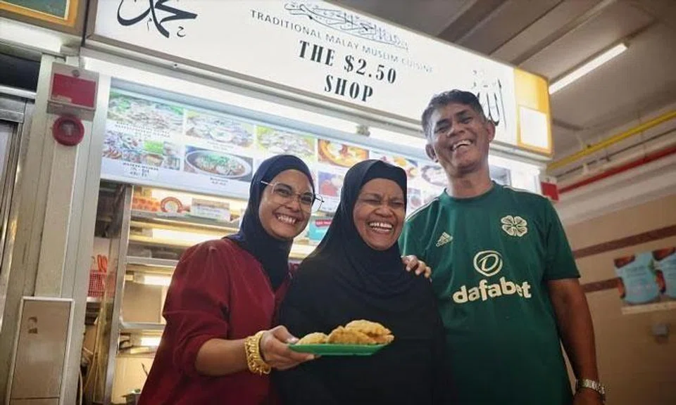 (From left) Ms Hani Isnin-Racine and her parents, Madam Munah and Mr Isnin, at their stall, The $2.50 Shop, in Jalan Kukoh. ST PHOTO: JASON QUAH