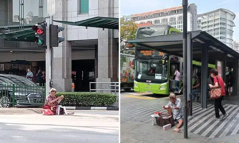 Elderly man sells tissue paper sitting in middle of pedestrian crossing and next to bus stop in Bugis