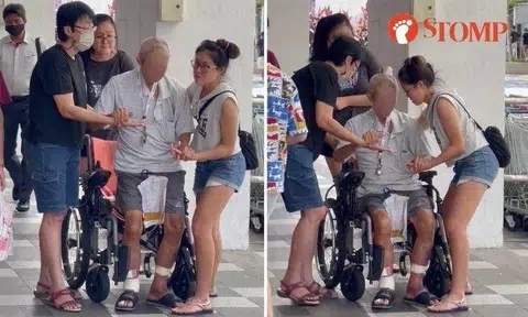 In the video, the women can be seen supporting the man and holding his hands as he carefully sat down on his wheelchair.