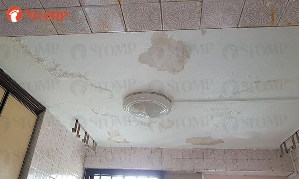 Ceiling leak from upper floor burst pipe damages resident's kitchen, repairs assisted by HDB