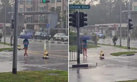 boy rides toy car in rain bukit timah