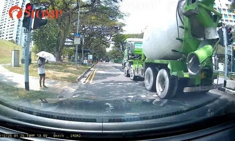 Saved by her phone? Cement truck could've hit distracted woman if she crossed road seconds earlier