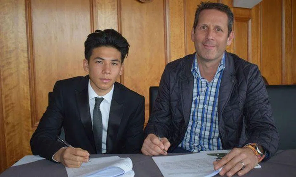 Ben Davis (left) signing his two-year scholarship deal with English Championship club Fulham. With him is his father Harvey Davis. Photo: Fulham FC