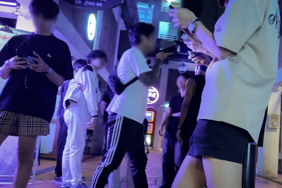 A group of young people with at least four vapes among them seen vaping outside a row of pubs in Prinsep Street on Aug 23.