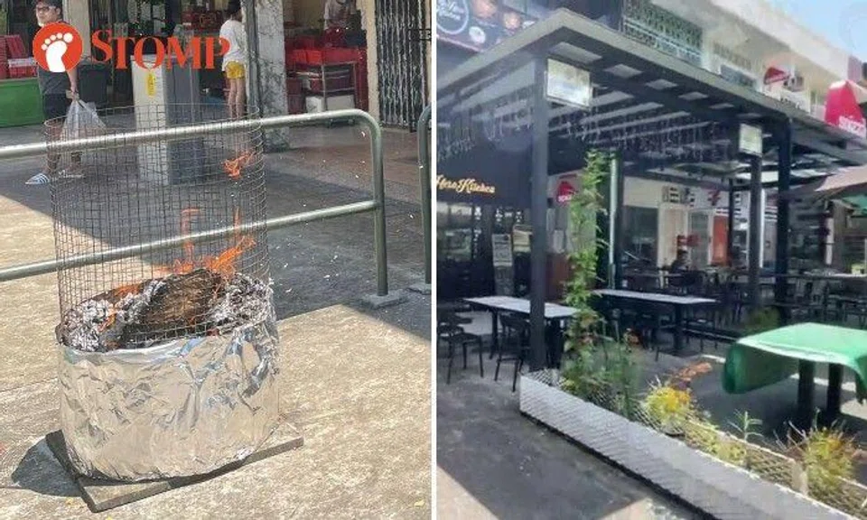 People were seen burning offerings outside a shop called Jane's Cake Station with the wind blowing the ashes towards the outdoor seating of two neighbouring restaurants, Lao Hero Kitchen and Spizza.