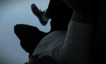 man kicks police officer