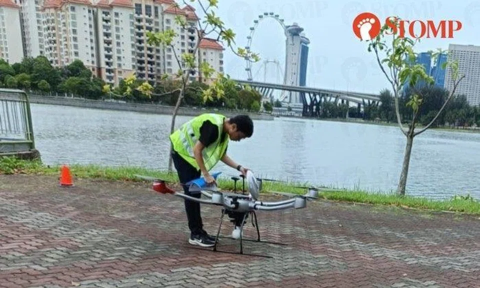 Stomper Tom shared photos taken at Bay Central showing a drone on the ground and a man in a green safety vest checking on it.