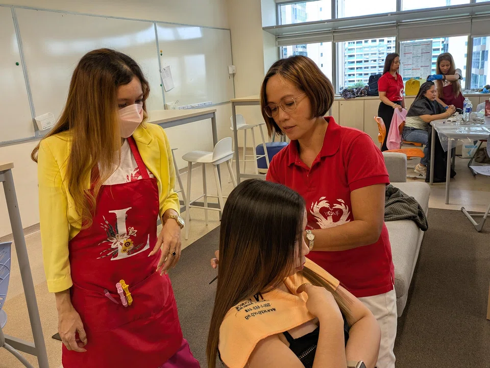 Ms Betty de Loreto (right) teaches hairdressing and cosmetology classes on a volunteer basis.