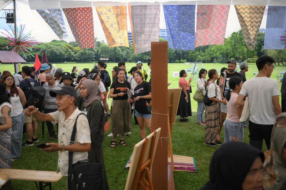 Visitors milling about the various booths during Hari Orang Pulau held at West Coast Park on June 14.