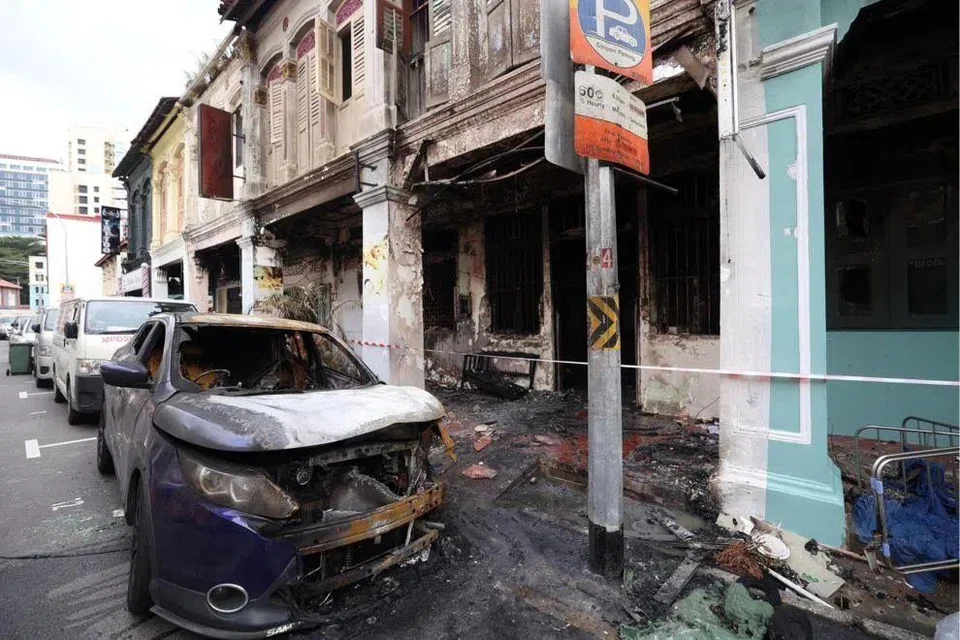 A blue car parked in front of the shophouse was also affected by the fire.