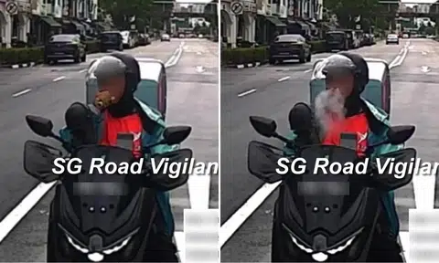 motorcyclist in lalamove uniform vapes on road