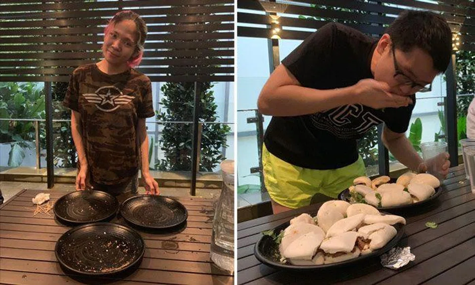 Malaysian top competitive eater Rainbow Kumi (left) and rookie Joshua Tan (right) participating in a pork bun eating contest at Attitude Inn.