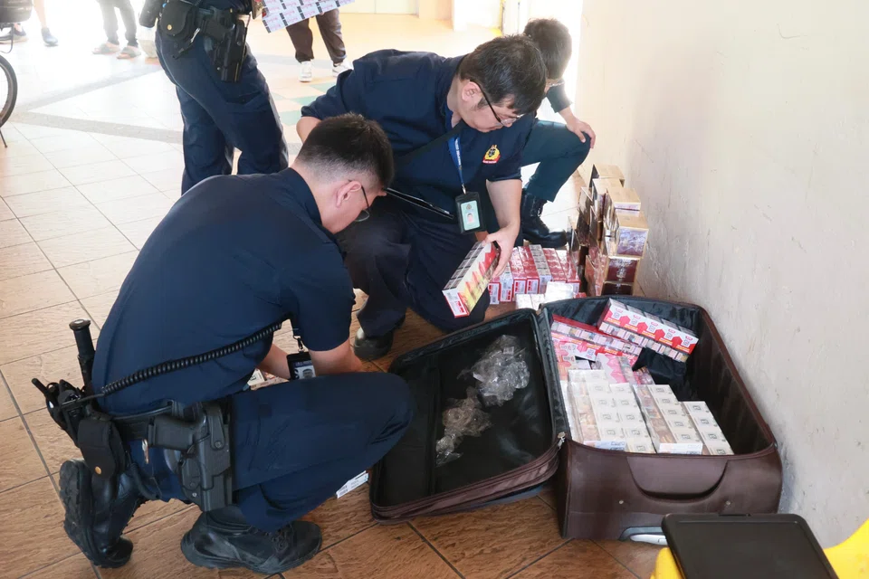 Officers from the Singapore Customs arrived to count the packets of cigarettes. 
