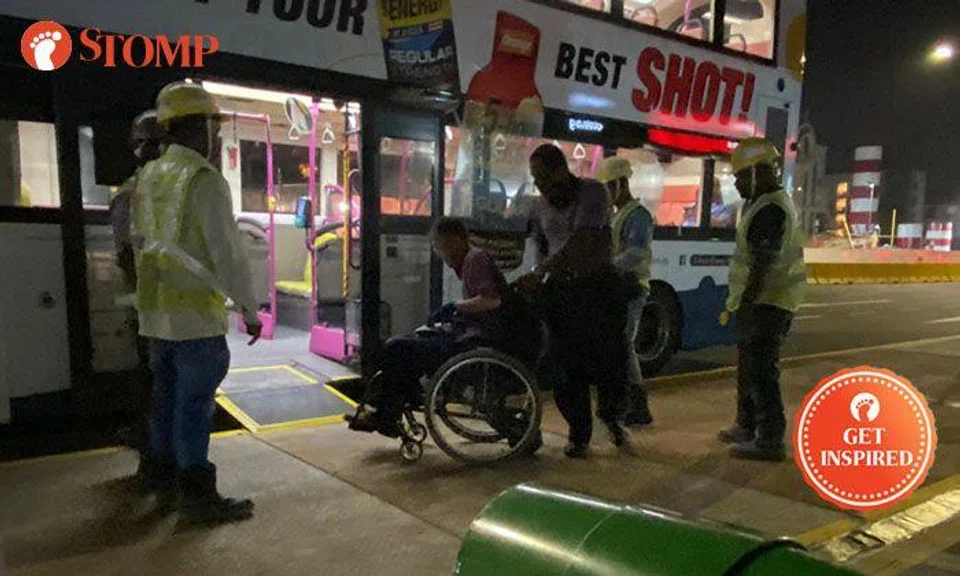 Workers carry elderly man in wheelchair to bus stop in Marine Parade: "Two thumbs up!"