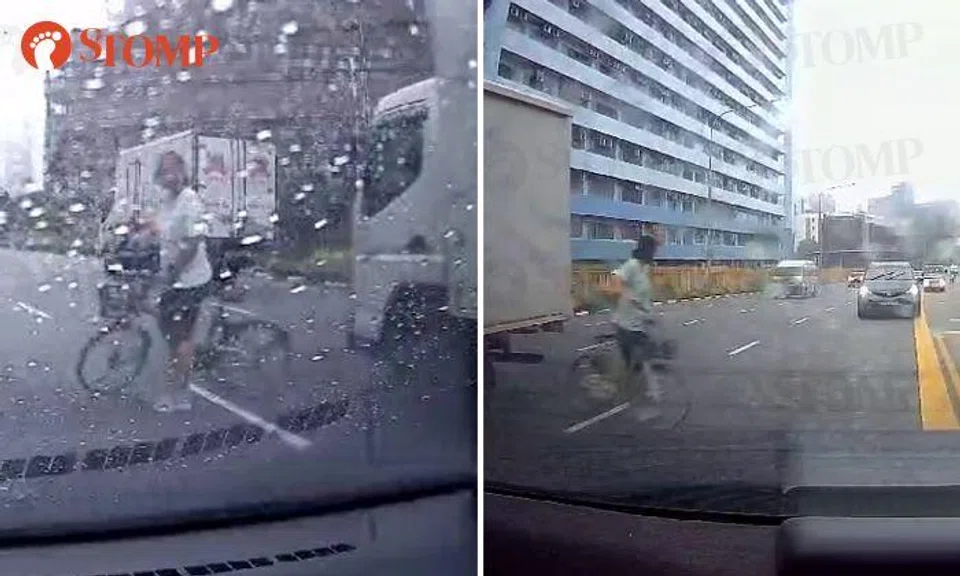 Courting death? Cyclist darts between vehicles at Zion Road on rainy day