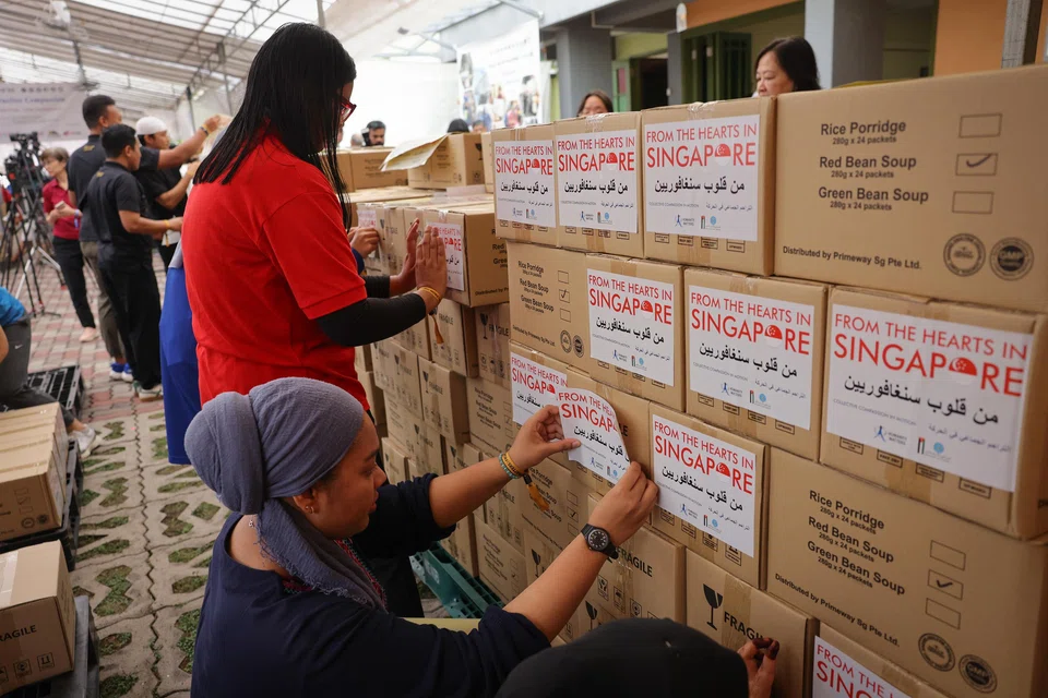 People packing aid in boxes for Gaza world news