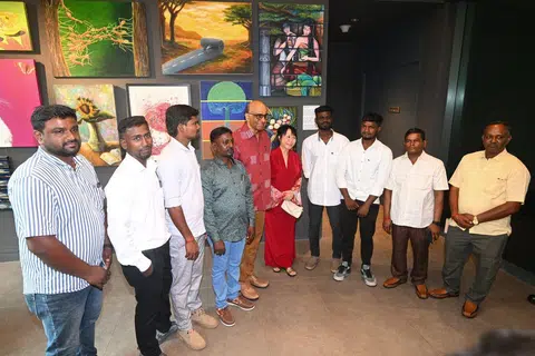 President Tharman Shanmugaratnam and his spouse, Ms Jane Ittogi (both centre), with the workers involved in the Tanjong Katong sinkhole rescue at the Istana open house on Aug 3.