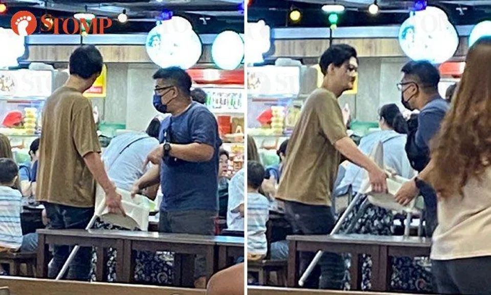 Men shout and argue over baby chair at The Centrepoint food court during lunchtime