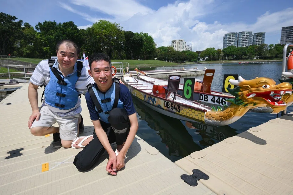 Mr Gary Chong (right), with his father Fabian, with a boat featuring his art.
