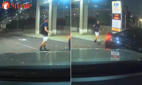 Youth on skateboard darts in front of car in Ghim Moh, turns back to 'challenge' driver