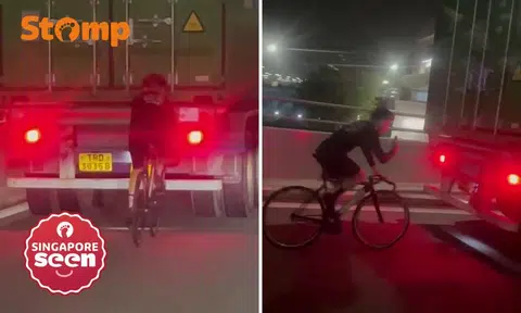 cyclist tailing trailer truck on west coast highway