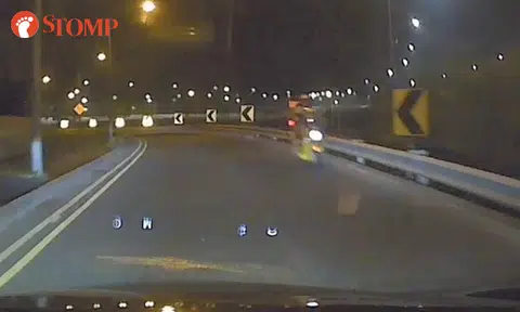 Motorcyclist riding against traffic along TPE