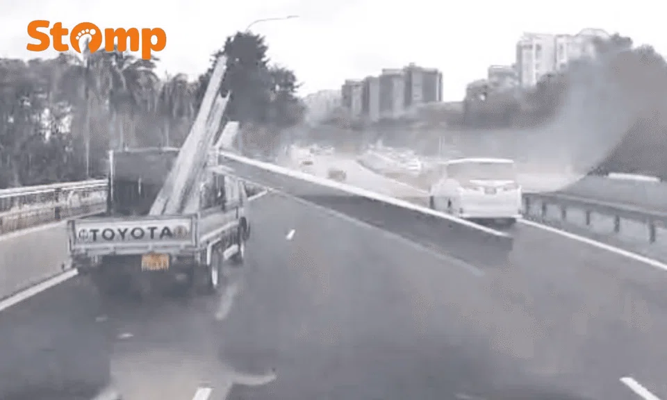A video still showing trunking flying off the back of a lorry and towards oncoming vehicles
