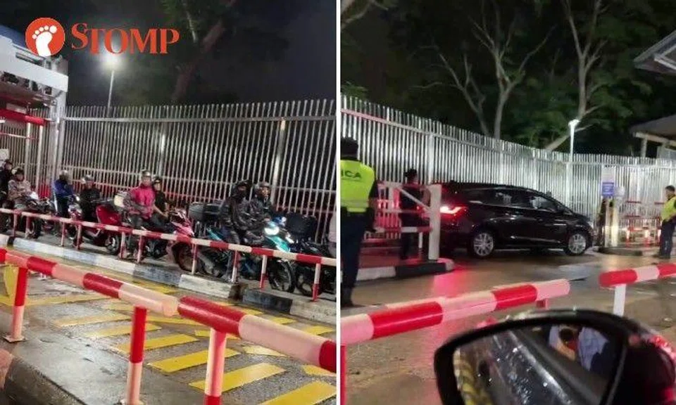The video also shows a line of motorcyclists waiting behind the car unable pass through.