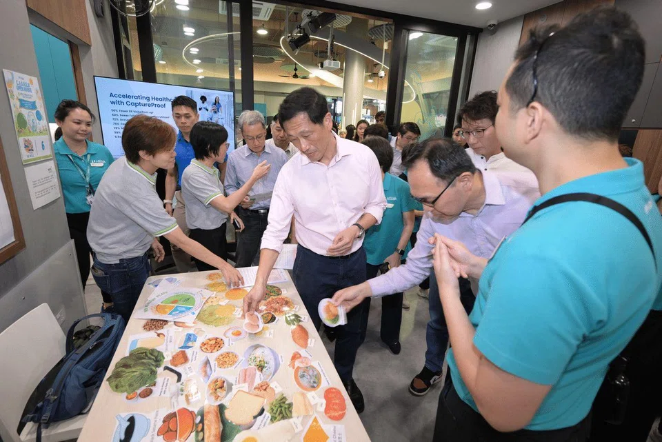 Health Minister Ong Ye Kung (centre), Bukit Panjang SMC MP Liang Eng Hwa (second from right) and Holland-Bukit Timah GRC MP Edward Chia (back row, right) at the launch of NTUC Health’s AAC in Bukit Panjang on Sept 19.