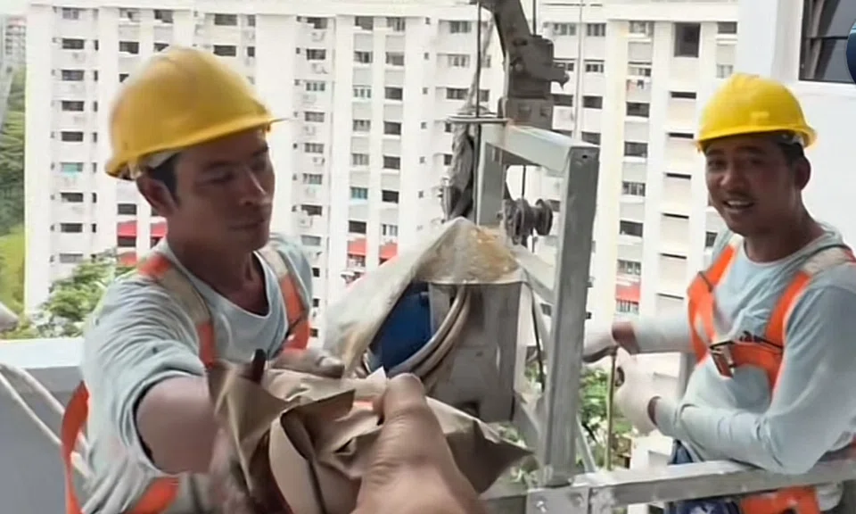 The two workers were pleasantly surprised by Mr Faisal's gift of nasi lemak and cigarettes. 